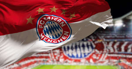 Munich, GER, May 2022: The Bayern Munich Flag waving in the wind with Allianz Arena Stadium blurred in the background. Bayern Munich is a German sports club based in Munich.のeditorial素材