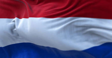 Close-up view of the Netherlands national flag waving in the wind. The Netherlands is a country...