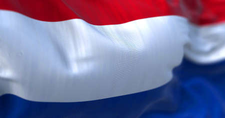 Close-up view of the Netherlands national flag waving in the wind. The Netherlands is a country located in Northwestern Europe. Fabric texture background. Selective focusの写真素材