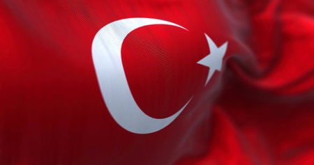 Close-up view of the Turkey national flag waving in the wind. Turkey is a transcontinental country...