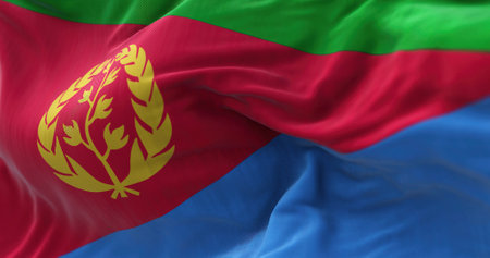 Close-up view of the Eritrea national flag waving in the wind. The State of Eritrea is a State located in the northern part of the Horn of Africa. Fabric textured background. Selective focusの写真素材