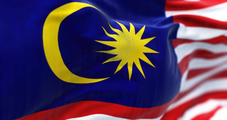 Close-up view of the Malaysia national flag waving in the wind. Malaysia is a federal state in Southeast Asia. Fabric textured background. Selective focusの写真素材