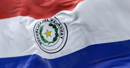 Close-up view of the Paraguay national flag waving in the wind. The Republic of Paraguay is a State of South America. Fabric textured background. Selective focusの写真素材