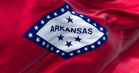 Close-up view of Arkansas state flag waving. Arkansas is a United States state. Fabric textured background. Selective focusの写真素材