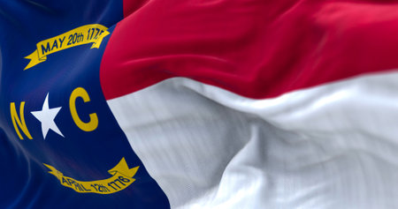Close-up view of the North Carolina state flag waving. North Carolina is a state in the Southeastern region of the United States. Fabric textured background. Selective focus. 3D illustrationの写真素材