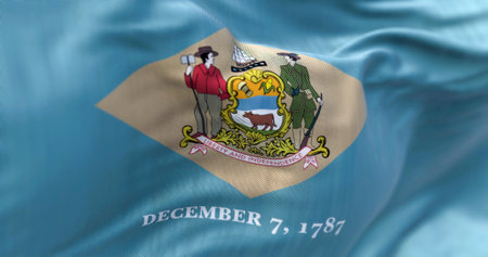 Close-up view of the Delaware state flag waving in the wind. Delaware is a state in the Mid-Atlantic region of the United States. Fabric textured background. Selective focus. 3D illustrationの写真素材
