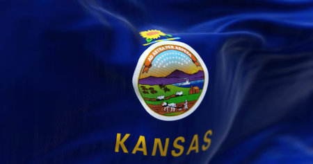 Close-up view of Kansas state flag waving in the wind. Kansas is a state in the Midwestern United States. Fabric textured background. Selective focus. 3D illustrationの写真素材