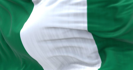 Close-up view of the Nigeria national flag waving. The Federal Republic of Nigeria, is a country in West Africa. Fabric textured background. Selective focus. 3D illustrationの写真素材