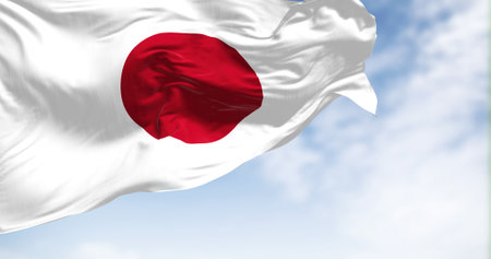 Close-up view of the Japan national flag waving in the wind. Japan is an island country in East...