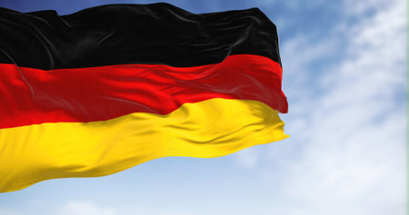 Germany national flag waving in the wind on a clear day. The Federal Republic of Germany is a country in Central Europe. Selective focus. 3d illustrationの写真素材