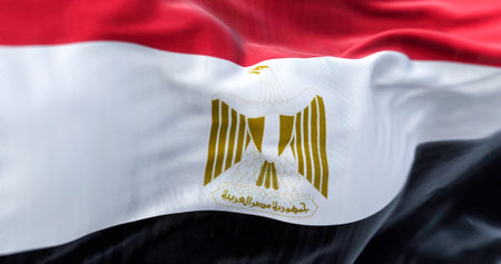Close-up view of the Egypt national flag waving in the wind. The Arab Republic of Egypt is a country in the northeast Africa. Fabric textured background. Selective focus. Realistic 3d illustrationの写真素材
