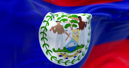Close-up view of the Belize national flag waving in the wind. Belize is an independent state in Central America. Fabric textured background. Selective focus. Realistic 3d illustrationの写真素材