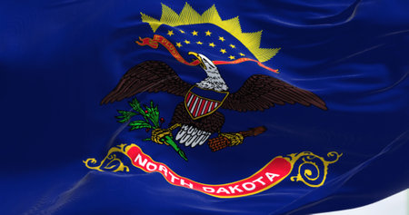 Close-up view of the North Dakota state flag fluttering. The flag shows the state contingent troop seal on dark blue background from Philippine-American War. Textured background. 3d illustrationの写真素材