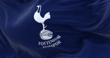 London, UK, Feb 2023: Tottenham Hotspur flag waving. White cockerel standing on a football. Rippled...