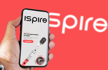 New York, USA, March 2023: Hand holding a phone with Ispire website on the screen. Financial...