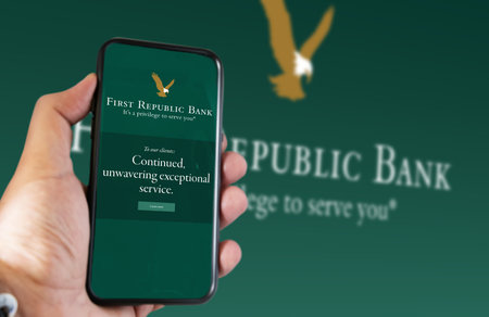 San Francisco, US, March 2023: Hand holding a phone with the First Republic Bank logo on the screen. In March 2023, First Republic Bank was rescued by a consortium with $30bn. Illustrative editorialのeditorial素材