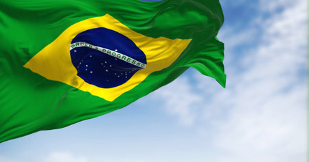 Brazil national flag waving on a clear day. Yellow diamond on green field with blue circle of 27 white, five-pointed stars. Fluttering fabric. Realistic 3d illustration.の写真素材