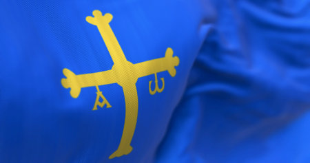 The Asturias flag waving. Autonomous community in northern Spain. Blue with golden victory cross shifted towards the hoist side. Selective focus. 3d illustration render. Close-up. Textured backgroundの写真素材