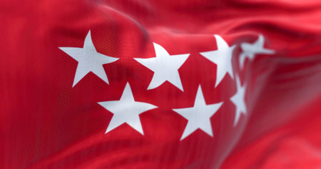 Detail of the Community of Madrid flag waving in the wind. Crimson red with seven silver five-pointed stars. 3d illustration render. Selective focus. Rippled textileの写真素材