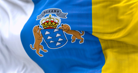 Detail of Canary Islands flag waving in the wind. the Canaries are a Spanish autonomous community. 3d illustration render. Selective focus. Close-up. Rippled textileの写真素材