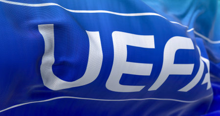 Nyon, CH, September 2022: flag with the UEFA logo waving in the wind. UEFA is the association that...