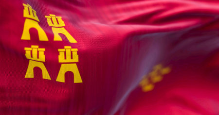 Detail of the Murcia flag waving. Autonomous community of Spain. Four castles and seven crowns on a crimson background. 3d illustration render. Selective focus. Close-up. Fluttering fabricの写真素材
