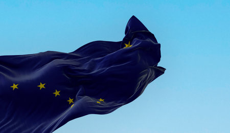 Alaska state flag waving in the wind on a clear day. Big dipper and polaris on a dark blue...