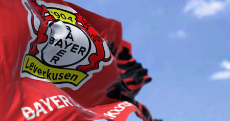 Leverkusen, DE, Apr. 2023: Fabric background with the Bayer Leverkusen flag waving. illustrative editorial 3d illustration render. Fluttering fabric. German Bundesliga Football clubのeditorial素材