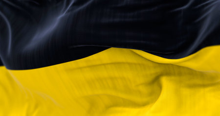 Civil flag of Baden-WÃ¼rttemberg waving in the wind. Black over gold bicor. German state. 3d illustration render. Selective focus. Close-up. Fluttering fabricの写真素材