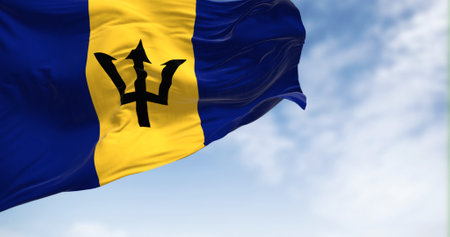 Barbados national flag waving on a clear day. Blue and yellow flag with a black Triton in the center. 3d illustration render. Fluttering fabricの写真素材