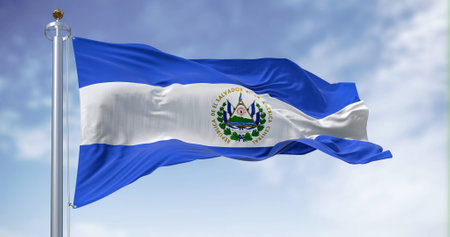 El Salvador national flag waving on a clear day. Three horizontal bands of blue and white with the coat of arms in the center. Central America country. 3d illustration render. Fluttering fabricの写真素材