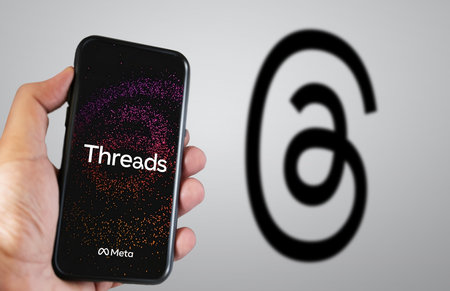 Menlo Park, US, June 24 2023: hand holding a mobile phone with the Threads application on the screen. Threads is an application developed by Meta to compete with Twitter. Illustrative editorialのeditorial素材