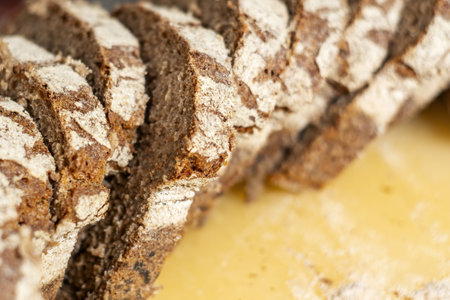 close-up view of some freshly cut slices of whole grain rye bread. Whole grain rye bread is made...