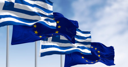 The flags of Greece and the European Union waving together on a clear day. Greece became a member of the European Union on 1981. 3d illustration render. International treaty and diplomacyの写真素材