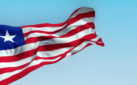 National flag of Liberia waving on a clear day. red and white horizontal stripes that change color and a white star on the blue square in the canton. 3d illustration render. Rippling fabricの写真素材