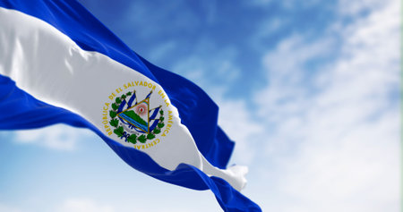 National flag of El Salvador waving in the wind on a clear day. Blue, white, and blue horizontal stripes, national coat of arms in the center. 3d illustration render. Selective focus. Rippling fabricの写真素材