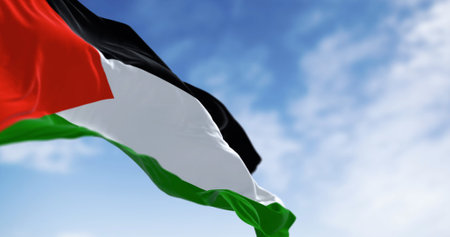 Palestine national flag waving on a clear day. Three black, white, green stripes with red triangle on left. 3d illustration render. Selective focus. Close-up. Rippling fabricの写真素材