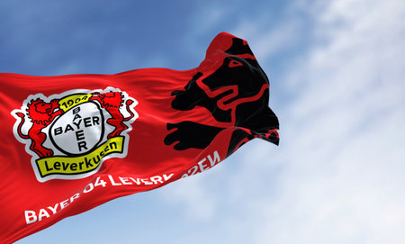 Leverkusen, DE, Nov. 2 2023: Bayer Leverkusen flag waving in the wind on a clear day. illustrative editorial 3d illustration render. Fluttering fabric. German Bundesliga Football clubのeditorial素材