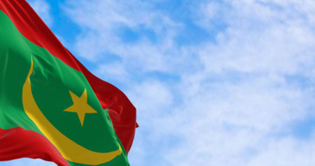Close-up of the Mauritania national flag waving in the wind. Green with yellow crescent, star between two red bands. 3d illustration render. Selective focus. Close-upの写真素材
