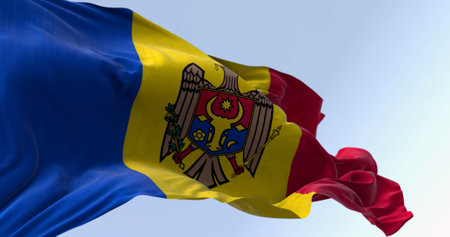 Moldova national flag waving in the wind on a clear day. vertical tricolor of blue, yellow, and red with the national coat of arms in the center. 3d illustration render. Fluttering fabricの写真素材