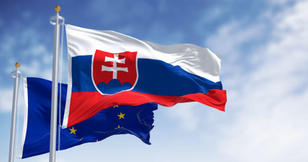 Slovakia and the European Union flags waving in the wind on a clear day. Slovakia is a member of the European Union and the Eurozone. 3d illustration render. Fluttering fabricの写真素材