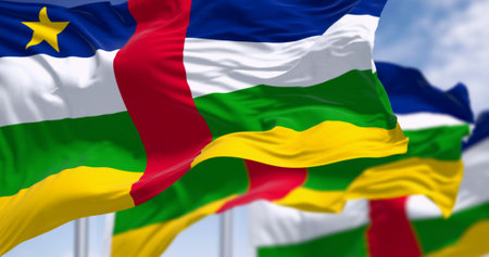 National flags of Central African Republic waving on a clear day. Blue, white, green, and yellow stripes with a red stripe in the middle and a yellow star in the canton. 3d illustration renderの写真素材