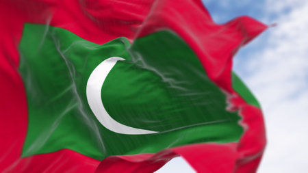Close-up of Maldives national flag waving. Flag is a green rectangle on red, with a white crescent moon in the center. 3d illustration render. Selective focus. Rippling fabricの写真素材