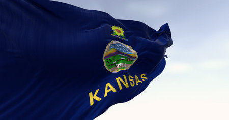 Close-up of Kansas state flag waving in the wind on a clear day. Kansas is a state in the Midwestern United States. 3d illustration render. Rippled Fabric.の写真素材