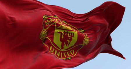 Manchester, UK, Oct. 2 2023: Close-up of Manchester United Football Club flag waving on a clear day....
