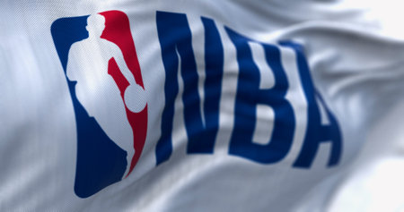 NYC, US, Feb. 5 2024; A close-up of the NBA flag waving. Iconic logo with a basketball player...
