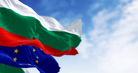 Flags of Bulgaria and the European Union waving in the wind on a clear day. Bulgaria became a member...