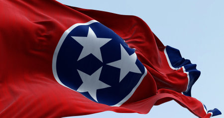 Close-up of the Tennessee state flag waving. Red field with a blue circle in the center containing three white stars. US state flag. 3d illustration render. Fluttering fabricの写真素材