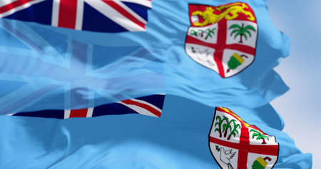National flags of FIji waving in the wind on a clear day. Fiji is an island country in Melanesia, part of Oceania in the South Pacific Ocean. 3d illustration render. Selective focus.の写真素材