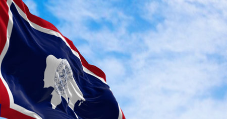 Close-up of Wyoming state flag waving in the wind. White Bison silhouette. 3d illustration render....